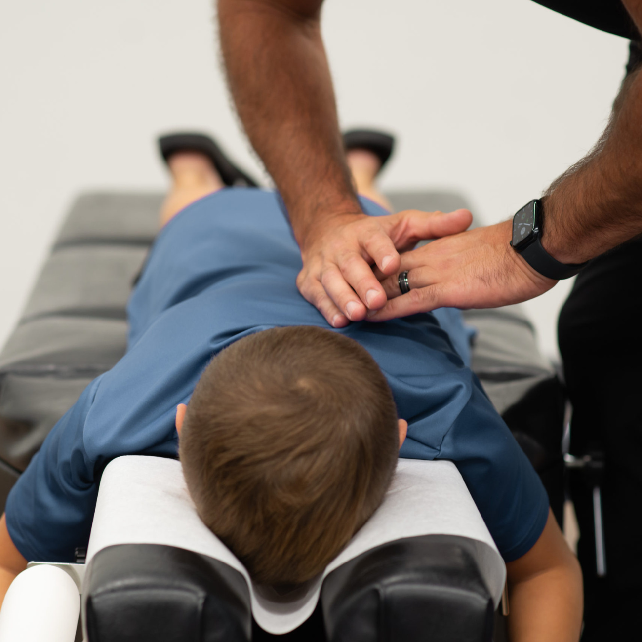 Teen receiving a chiropractic adjustment to support posture, growth, and overall well-being during adolescence.