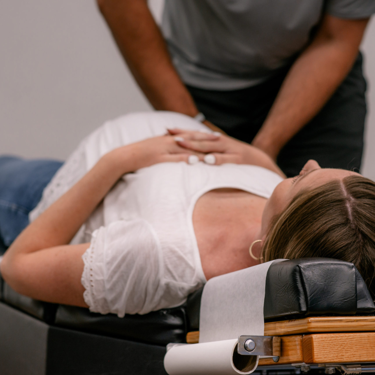 Pregnant woman receiving gentle chiropractic adjustment to support comfort, alignment, and overall wellness during pregnancy.